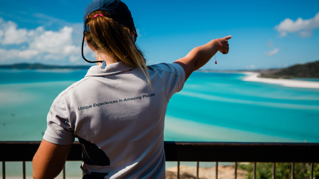 Explore staff member pointing out Hill Inlet in the Whitsundays