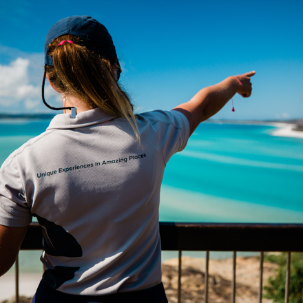 Explore staff member pointing out Hill Inlet in the Whitsundays